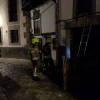 Varios bomberos en la calle, junto a la vivienda del incendio