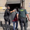 Dos guardia civiles llevando un detenido