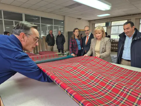 Un trabajador muestra una pieza de tejido durante la visita institucional